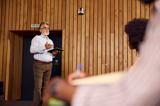 Man Giving a Presentation to a Small Audience 