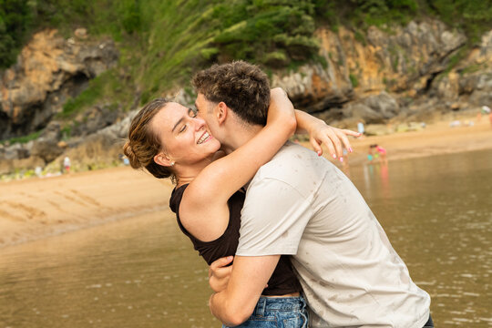 Couple Enjoys Time Together by the Water at the Beach