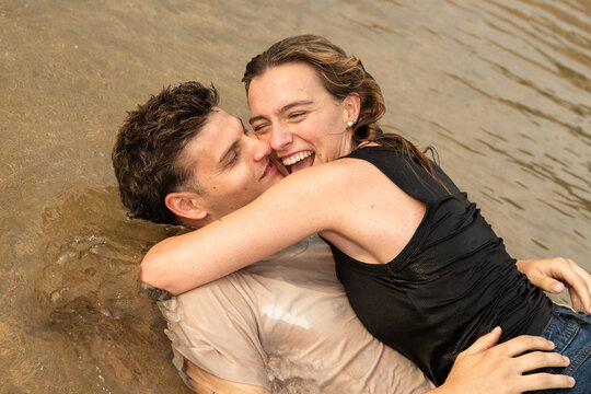 Couple Enjoying Time Together in Shallow Water in the Beach