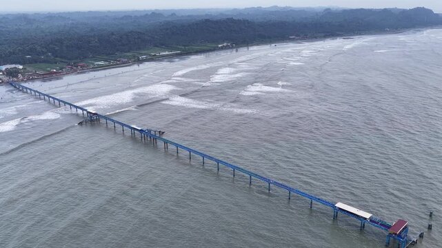 Aerial view of BD Navy Jetty extending into the sea with waves crashing along the coastline in Cox's Bazar District, Chittagong Division, Bangladesh.
