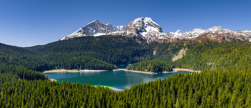 Drone shot - Black Lake and snowy peaks in Durmitor