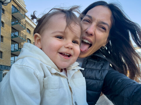 Happy Parent And Toddler Sharing Fun Riverside Selfie In London