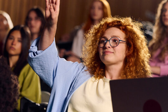 Student puts forward a question during a lecture.