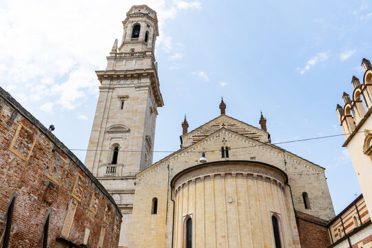 Verona Cathedral Exterior Architecture with High Bell Tower and Stone Apse Facade in Verona, Italy.
