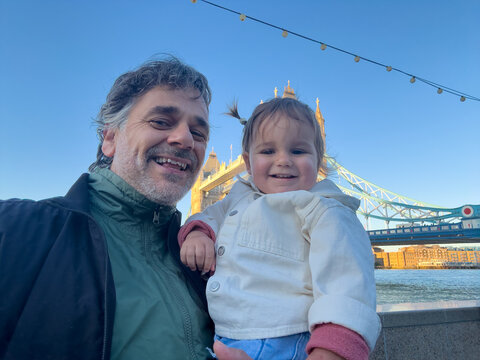 Smiling Parent And Toddler Posing Near Tower Bridge London 