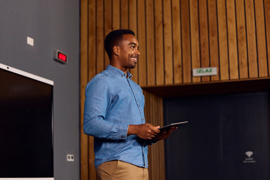Young man is addressing the class in the lecture room.