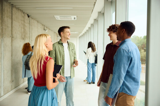 College students talk to each other inside the building