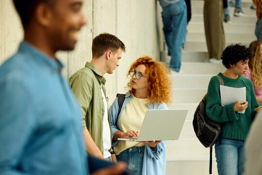 Two People Looking at a Laptop At The University