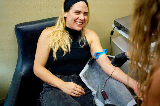 Smiling woman having a PRP blood draw