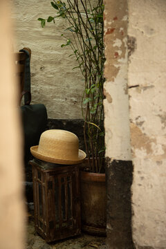woven hat in a corner of a rustic setting