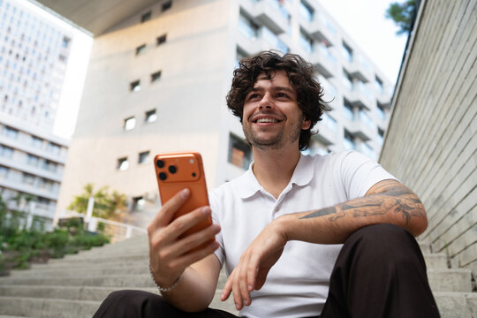 A man uses a mobile phone in the city