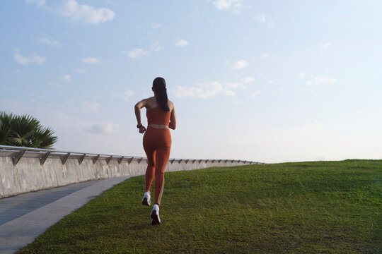 Silhouette of woman running at sunrise
