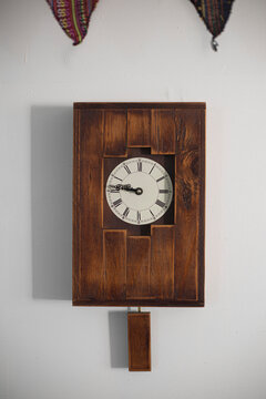 brown wood retro clock against the wall