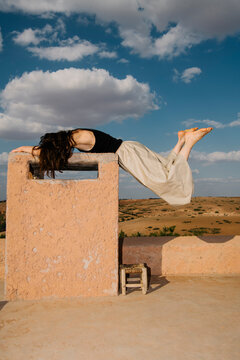 Barefoot Relaxation on Desert Rooftop Under Clouds