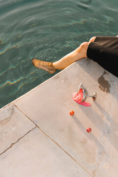Relaxing Legs Dipped in Water by Poolside