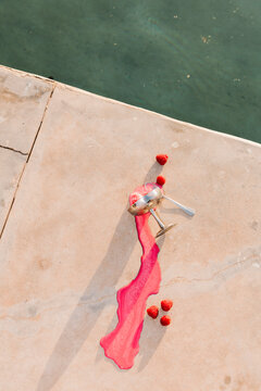 Spilled Strawberry Drink by Poolside Glass