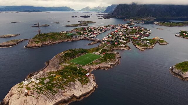 Aerial view of the iconic football pitch located on a rocky island in the village of Henningsvaer surrounded by the sea in Henningsvaer, Nordland, Norway.
