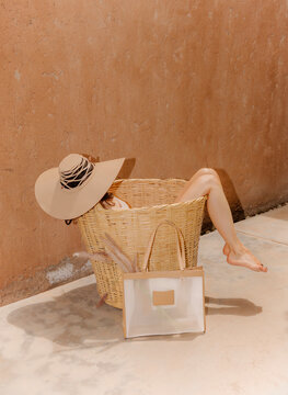 Relaxing In Wicker Basket With Sun Hat