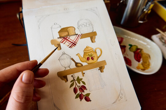 Artist painting a cozy kitchen watercolor illustration in sketchbook