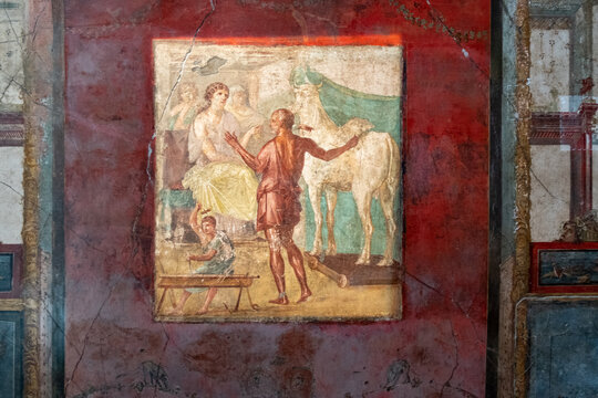 Ancient Roman fresco of Daedalus presenting the wooden cow to Queen Pasiphae, House of the Vettii ruins in Pompeii