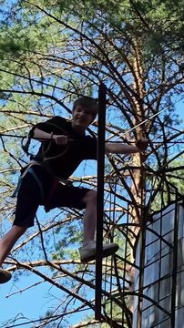 Climbing a ladder in a forested area during the day