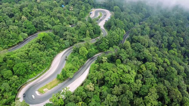 Aerial view of winding road through the lush forest of Panatapan Berastagi, Berastagi, North Sumatra, Indonesia.