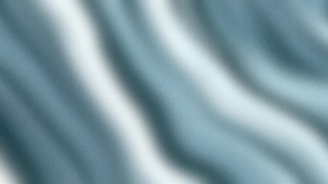 Soft flowing folds of blue fabric creating gentle waves that cascade through the frame with subtle light and shadow play to produce a calming visual movement for creative artistic design projects
