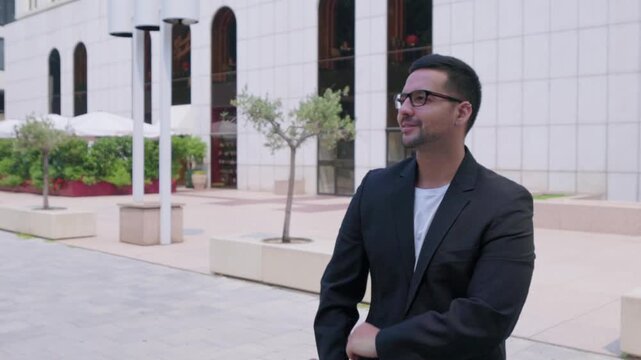 Confident technology startup founder waiting for partner in city square
