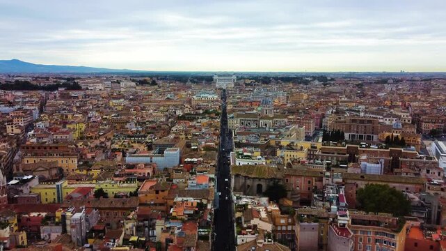 Aerial view of Via del Corso stretching through the historic city center with dense rooftops and urban architecture in Roma, Lazio, Italy.