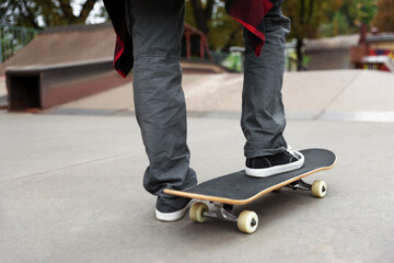 Man riding skateboard on city street, closeup © New Africa