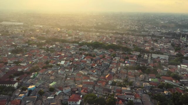 Aerial view of dense residential rooftops and urban sprawl in Depok, West Java, Indonesia.