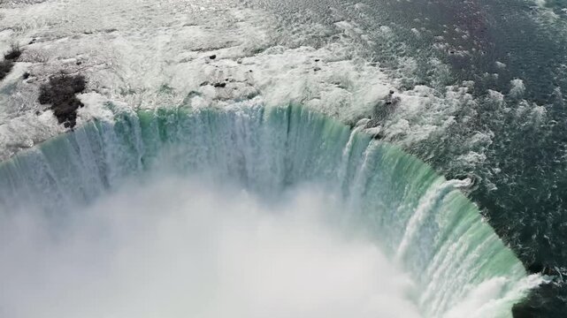 Aerial view of the powerful Horseshoe Falls with mist rising from the cascading water in Niagara Falls, Ontario, Canada.