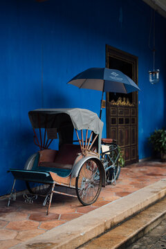 PENANG, MALAYSIA - JUN 02, 2026: Traditional rickshaw displayed outside Cheong Fatt Tze Blue Mansion in George Town, Penang, Malaysia.