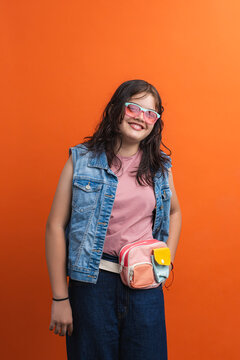 Smiling girl posing with fanny pack and sunglasses