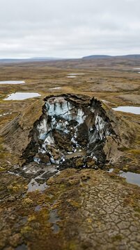 Collapsing Pingo Ice Mound in Arctic Tundra Landscape