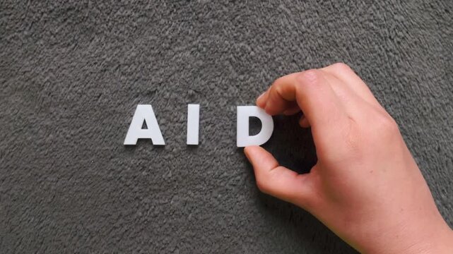 The word aids written on a dark background with white uppercase block letters (fast version)
