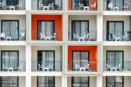Modern hotel building with colorful balconies, travel holiday leisure background