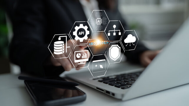 Business Professional Using Laptop for Technology Integration with Data Analytics, Cloud Computing, Security Icons, and API Connections Quark.
