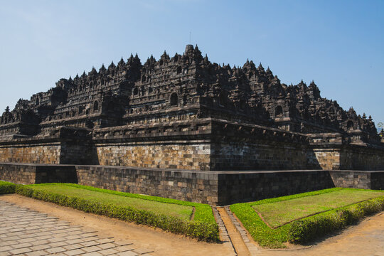 Monumental Stepped Pyramid Structure of Borobudur Temple with Stone Pathway and Manicured Lawns in Central Java near Yogyakarta Indonesia