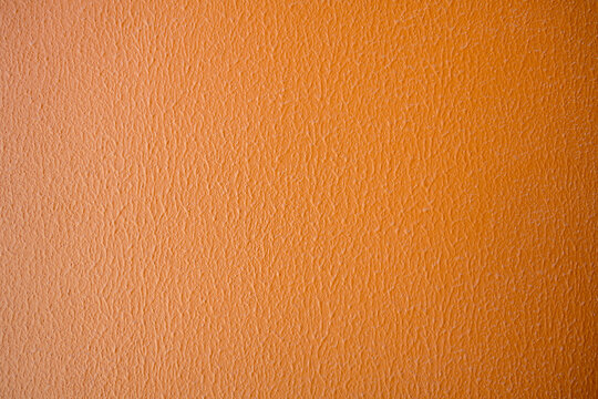 Orange textured wall background, warm color abstract texture for design and copy space Keywords
