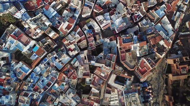 Aerial view of the blue-painted buildings and terracotta rooftops of the historic medina in Chefchaouen, Tangier-Tetouan-Al Ho, Morocco.
