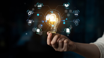 Bright Idea Concept with Business Icons and Light Bulb in Hand Representing Innovation and...