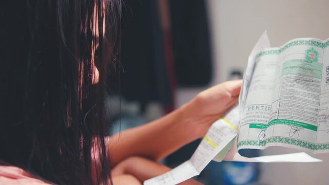 Woman Seriously Reading Important Financial Document or Bill (OTS)
