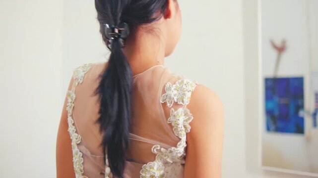 Woman Posing in White Dress Showing Sheer Back Detail and Ponytail