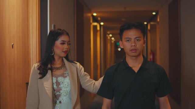 Elegant Woman Stops Man in Hotel Hallway, They Walk Away