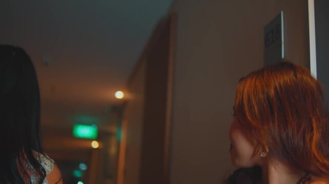 Dutch Angle Shot of Women Exchanging Condom Packet in Hotel