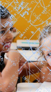 Mathematical equations and graphs animation over children studying in classroom