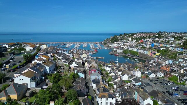Brixham, Devon, England: DRONE VIEWS: 1. The residential district of the town of Brixham; 2. The inner and outer harbour with moored trawlers and yachts. Brixham is the UK's leading fishing port.