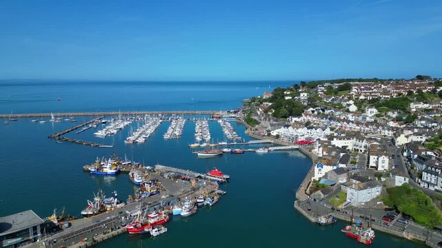 Brixham, Devon, England: DRONE VIEWS: 1. The residential district of the town of Brixham; 2. The inner and outer harbour with moored trawlers and yachts. Brixham is the UK's leading fishing port.
