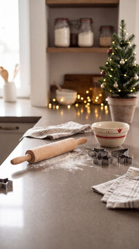 A rustic kitchen countertop covered in dusting flour with a wooden rolling pin dough and a potted mini Christmas tree in a warm domestic setting